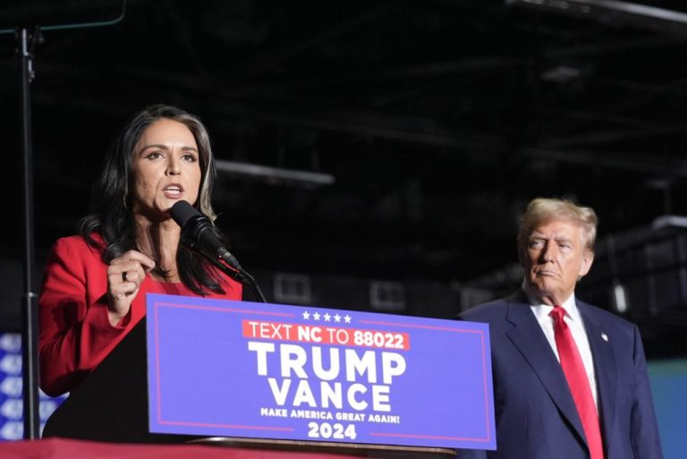 Former Democratic Rep. Tulsi Gabbard speaks as Republican presidential nominee former President Donald Trump listens during a campaign rally at Greensboro Coliseum, Tuesday, Oct. 22, 2024, in Greensboro, N.C.