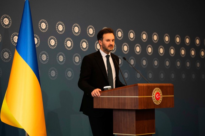 Heorhii Tykhyi speaks at a podium