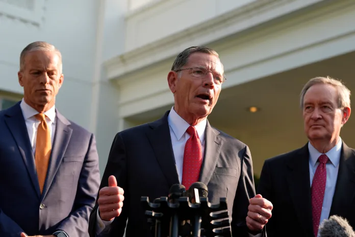 Senate Majority Leader John Thune, R-S.D., and Sen. Mike Crapo, R-Idaho, listen as Sen. John Barrasso, R-Wyo., speaks with reporters