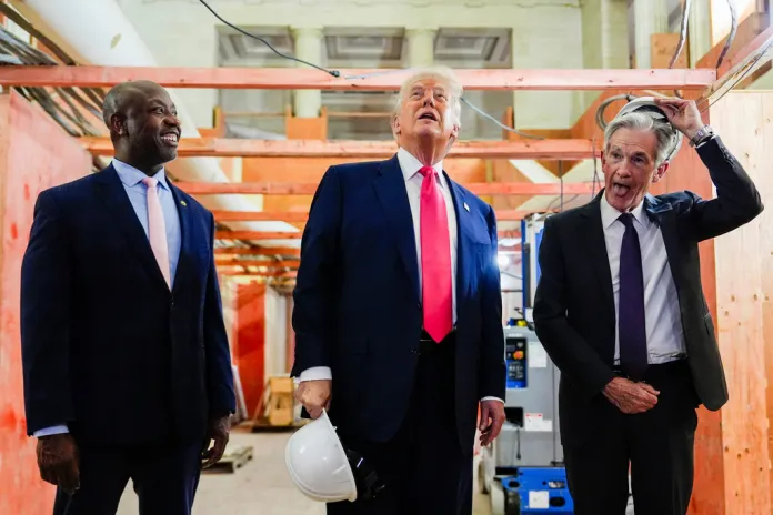 Federal Reserve Chairman Jerome Powell, right, takes off his hard hat as President Donald Trump, center, and Sen. Tim Scott (R-SC), left, look at construction at the Federal Reserve.