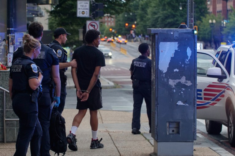 Washington Metropolitan Police Department takes a person into custody in the Navy Yard neighborhood of Washington on Aug. 13, 2025.