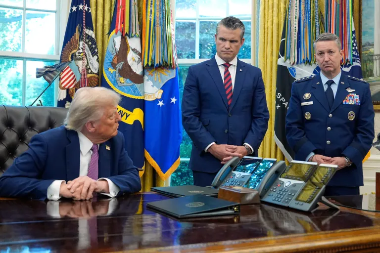 President Donald Trump looks to Defense Secretary Pete Hegseth and Chairman of the Joint Chiefs of Staff Gen. Dan Caine as he speaks in the Oval Office