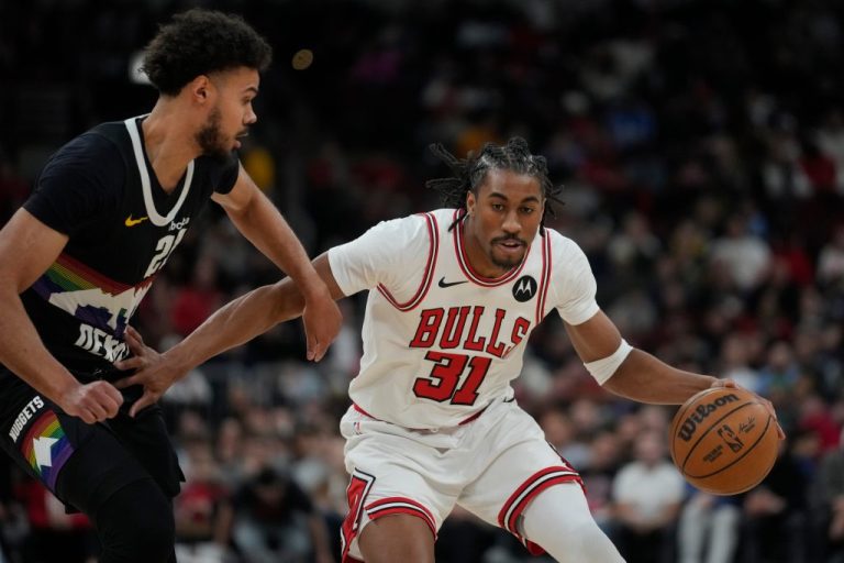 Denver Nuggets forward Spencer Jones (21), left, guards Chicago Bulls guard Jaden Ivey (31) during the first half of an NBA basketball game Saturday, Feb. 7, 2026, in Chicago.