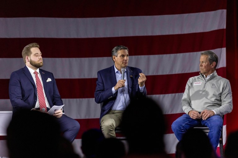 Georgia Gov. Brian Kemp, right, listens as Derek Dooley, center, a Republican candidate for Senate in Georgia, center, speaks during an Atlanta Young Republicans campaign event Thursday, Feb. 12, 2026, in Atlanta.
