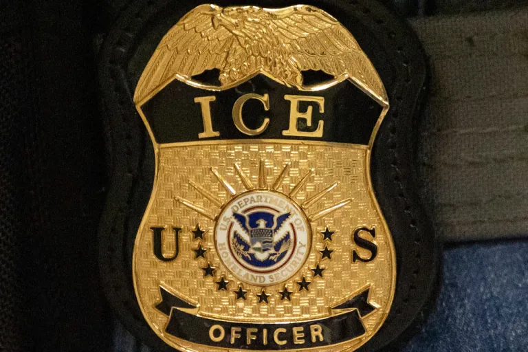 FILE - A federal agent wears an Immigration and Customs Enforcement badge in New York, June 10, 2025. (AP Photo/Yuki Iwamura, File)