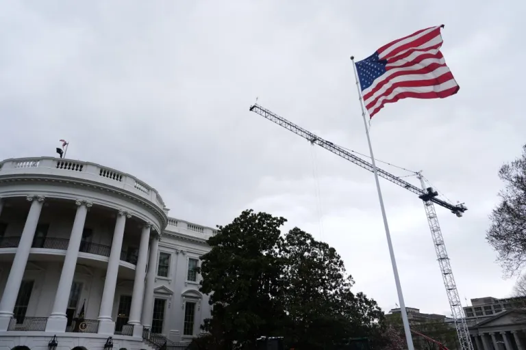 An American flag waves on the South Lawn of the White House.