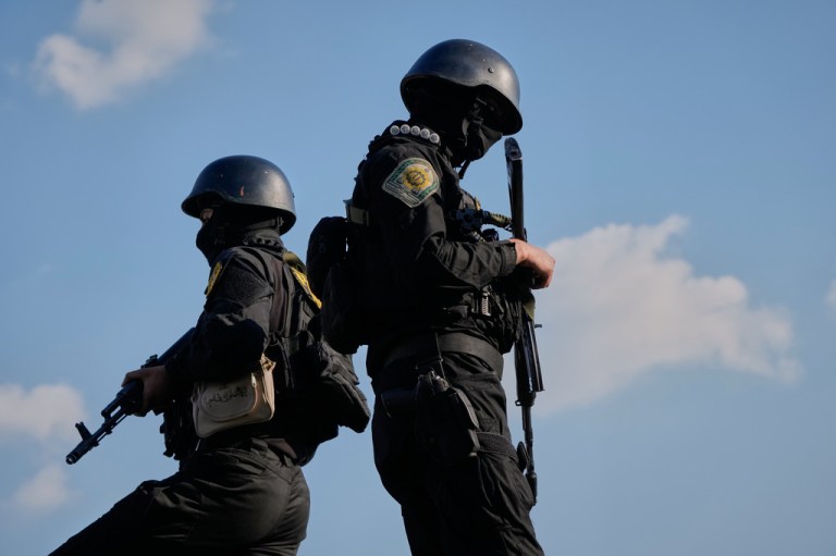 Iranian police special forces stand guard during a funeral procession