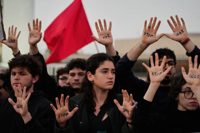 People raise their hands during a protest calling for an end to the war in Tel Aviv, Israel, Saturday, April 4, 2026.