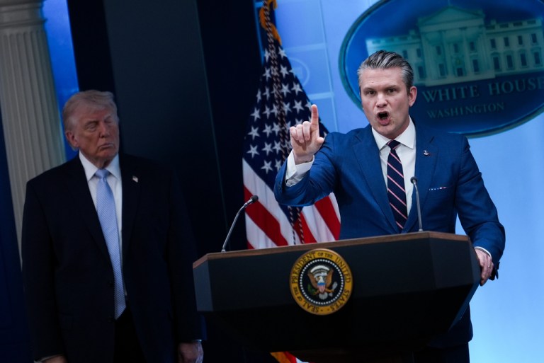 President Donald Trump watches as Defense Secretary Pete Hegseth speaks with reporters in the James Brady Press Briefing Room at the White House, Monday, April 6, 2026, in Washington.