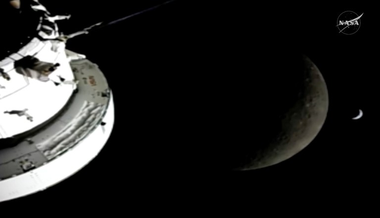In this image from video provided by NASA, the Orion Spacecraft, the Earth and the Moon are seen from a camera as the Artemis II crew and spacecraft travel farther into Space, Monday, April 6, 2026.