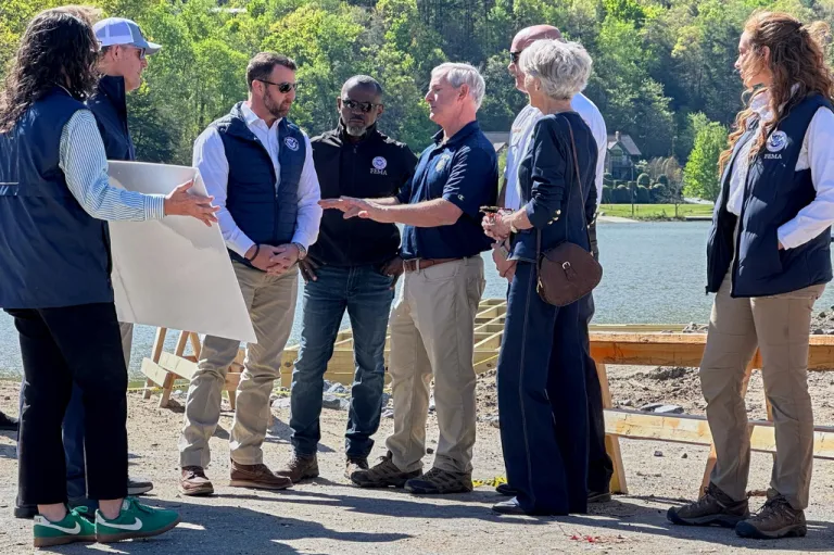 Homeland Security Secretary Markwayne Mullin, center left, listens to a briefing on hurricane recovery efforts, Tuesday, April 7, 2026 in Lake Lure, N.C. This is his first official trip since replacing Kristi Noem.
