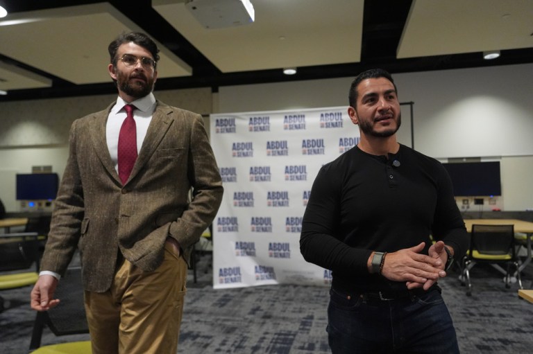 Hasan Piker, left, listens as Abdul El-Sayed, a progressive candidate in the Democratic primary for U.S. Senate in Michigan, speaks in a green room before a campaign rally, Tuesday, April 7, 2026, at the University of Michigan in Ann Arbor, Mich