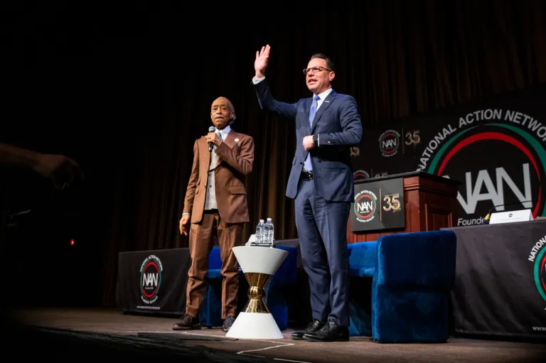 Josh Shapiro, Governor of Pennsylvania, waves to the audience after speaking with Reverend Al Sharpton during the National Action Network (NAN) Convention in New York, Wednesday, April 8, 2026. (AP Photo/Angelina Katsanis)