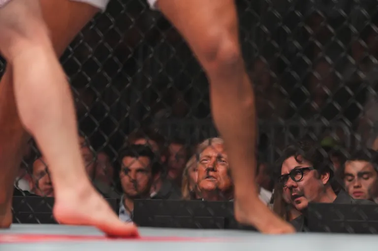 President Donald Trump and Hunter Campbell, right, watch a fight during UFC 327 at Kaseya Center, Saturday, April 11, 2026, in Miami.