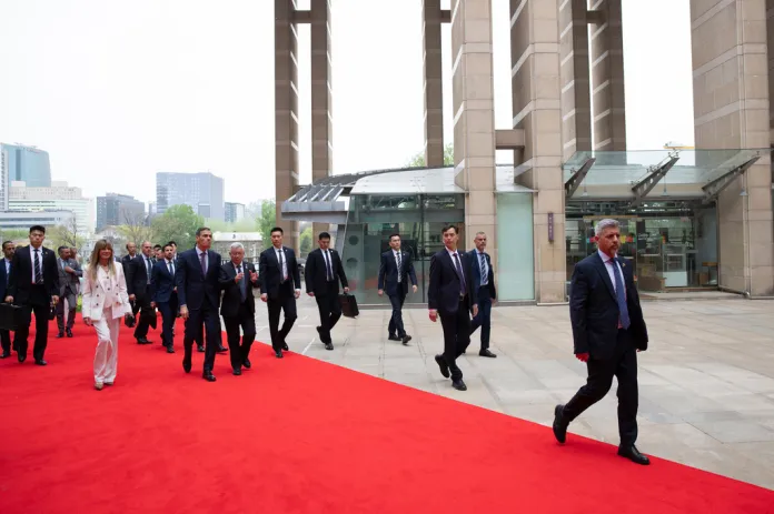 Spanish Prime Minister Pedro Sanchez, center left, and his wife Begona Gomez, left, arrive at the University of Chinese Academy of Sciences in Beijing, Monday, April 13, 2026.