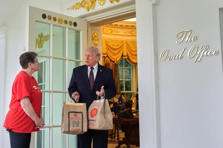 President Donald Trump speaks to a woman from Door Dash