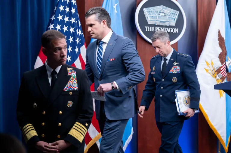 War Secretary Pete Hegseth steps away from the podium with Chairman of the Joint Chiefs of Staff Gen. Dan Caine, right, and Adm. Brad Cooper, left, following a press briefing at the Pentagon, Thursday, April 16, 2026 in Washington.