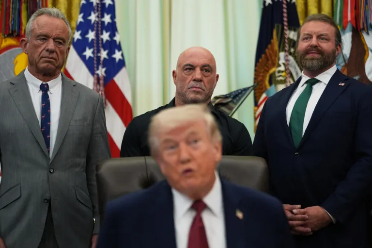 Behind President Donald Trump, from left, U.S. Secretary of Health and Human Services Robert Kennedy Jr., Joe Rogan and W. Bryan Hubbard, CEO of American for Ibogaine, listens to the president speak in the Oval Office of the White House, Saturday, April 18, 2026, in Washington.