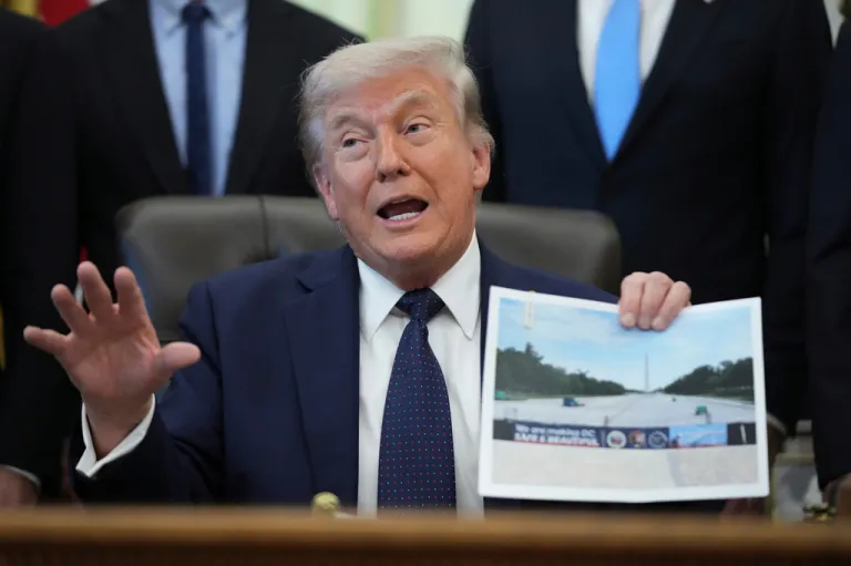 President Donald Trump holds a picture of the Lincoln Memorial Reflecting Pool during an event on health care affordability in the Oval Office at the White House, Thursday, April 23, 2026, in Washington.