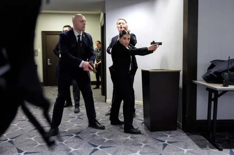 Members of law enforcement respond during the White House Correspondents' Association dinner, Saturday, April 25, 2026, in Washington. (AP Photo/Tom Brenner)