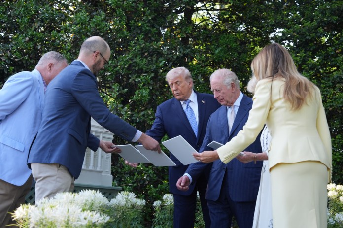 President Donald Trump and Britain's King Charles III look at the White House garden and bee hive on the South Lawn of the White House, Monday, April 27, 2026, in Washington.