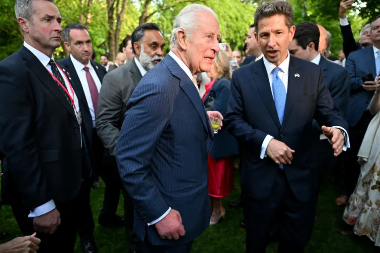 Britain's King Charles III speaks with Christian Turner, British ambassador to the United States, during a garden party at the British Embassy, Monday, April 27, 2026.