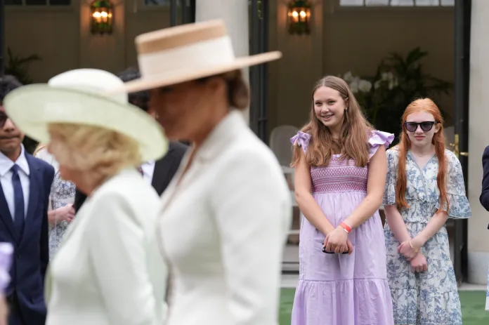 Girls smile as first lady Melania Trump and Britain's Queen Camilla attend a cultural education event at the White House Tennis Pavilion.