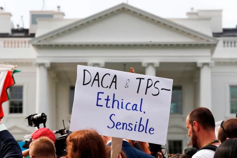 A person holds up a sign in support of the Deferred Action for Childhood Arrivals, known as DACA, and Temporary Protected Status programs during a rally in support of DACA and TPS outside of the White House, Sept. 5, 2017. (AP Photo/Jacquelyn Martin, file)