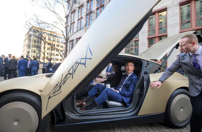 Transportation Secretary Sean Duffy sits in a Tesla Cybercab autonomous vehicle during the National AV Safety Forum at the U.S. Department of Transportation on March 10 in Washington. (Rod Lamkey, Jr./AP)