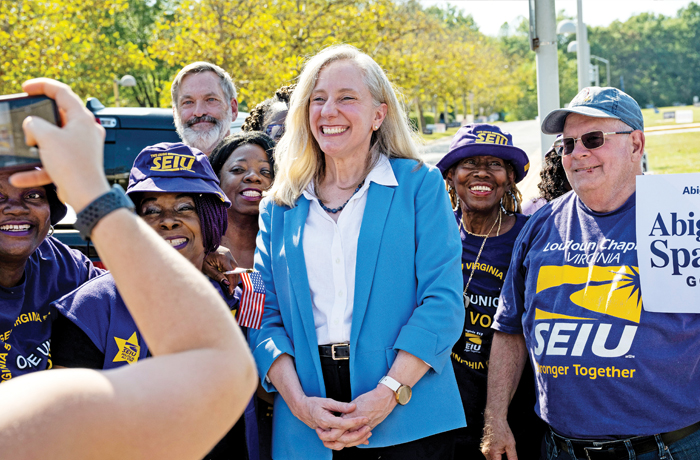 Democratic candidate for governor of Virginia Abigail Spanberger poses with government union supporters at a polling station in Fairfax, Virginia, Sept. 19, 2025.