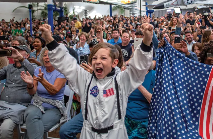 Americans watch and celebrate the Artemis II crew’s splashdown, marking the successful return of NASA’s first crewed lunar flyby mission in more than 50 years, April 10, San Diego, California. (Apu GOMES/Getty Images)