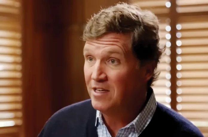 Tucker Carlson in a March 2026 interview with the Economist’s editor-in-chief Zanny Minton Beddoes. (Economist via YouTube)