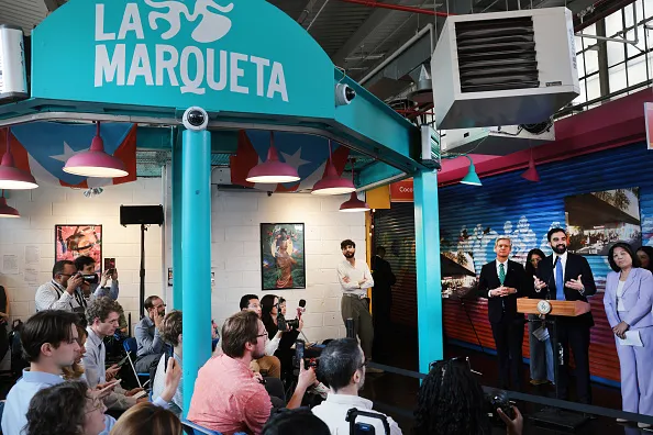 New York City Mayor Zohran Mamdani attends a news conference where he announced the first of the city-run grocery stores: La Marqueta in East Harlem on April 14, 2026, in New York City. A key campaign promise, Mamdani has pledged a city-run grocery store in every borough of New York City, where residents can buy discounted produce and other healthy foods. According to city officials, the city-run supermarkets are intended to help New Yorkers who struggle to afford fresh, healthy food in their neighborhoods. After Los Angeles, New York City has the highest childhood hunger rate in the nation.