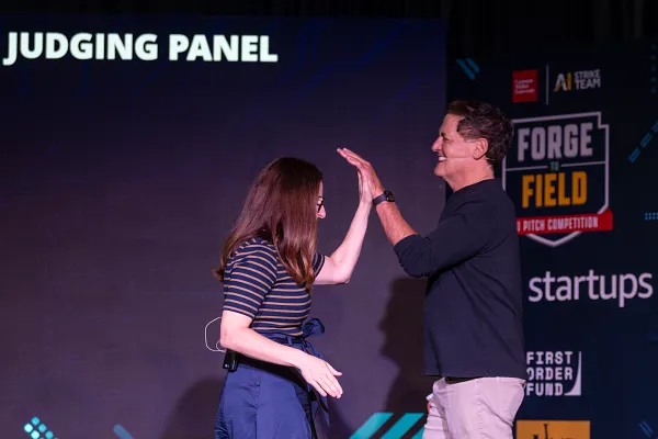 Mark Cuban high fives a woman during the Carnegie Mellon University’s Robotics Innovation Center in Pittsburgh.