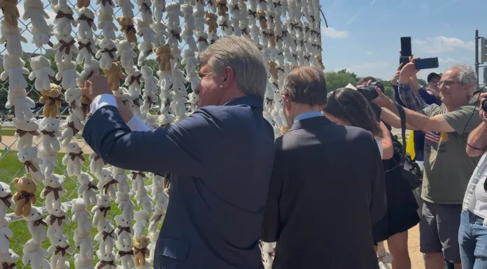 Rep. Michael McCaul (R-TX) and Sen. Richard Blumenthal (D-CT) attaching teddy bears to the installation. (Photo by Emily Robertson/Washington Examiner)