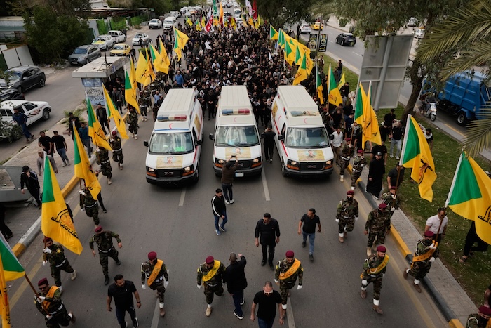 Members of an Iraqi Shiite militant group attend a funeral of a fighter with the Kataib Hezbollah, who was killed in a U.S. airstrike in Basra province south of Baghdad, Iraq, Wednesday, April 8, 2026. (AP Photo/Hadi Mizban)