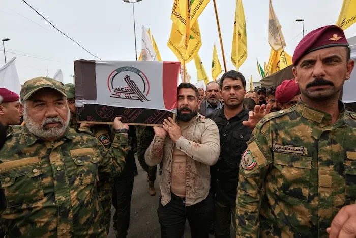 Members of the Popular Mobilization Forces attend a funeral of fighters who were killed in a U.S. airstrike, in Tal Afar, Nineveh province, north of Baghdad, Iraq, Thursday, April 2, 2026. (AP Photo/Hadi Mizban)