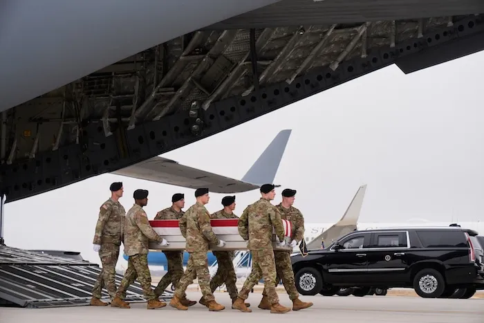 An Army carry team moves a flag-draped transfer case with the remains of U.S. Army Reserve soldier Maj. Jeffrey O'Brien.