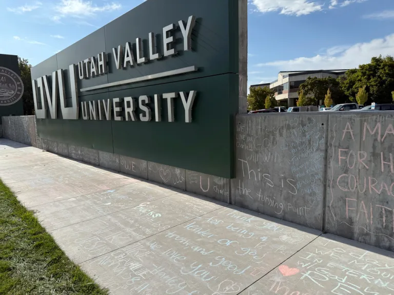 People who brought flowers also wrote messages in chalk at a memorial for Charlie Kirk, who was shot and killed last week, at Utah Valley University.