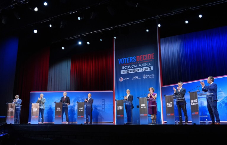 From left: Tony Thurmond, Chad Bianco, Tom Steyer, Steve Hilton, Xavier Becerra, Katie Porter, Matt Mahan and Antonio Villaraigosa stand on stage during a California gubernatorial debate at Pomona College in Claremont, California on April 28. (Jae C. Hong/AP)