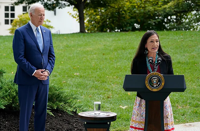 President Joe Biden listens as Interior Secretary Deb Haaland speaks at an event at the White House on Oct. 8, 2021. (Susan Walsh/AP)