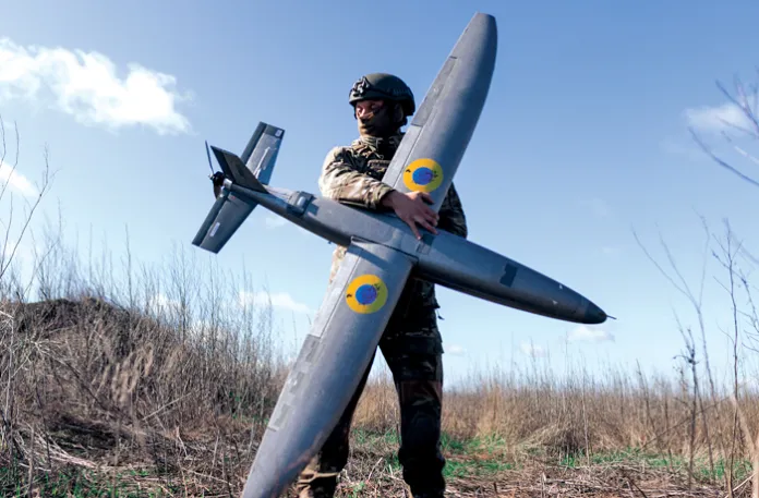 A Ukrainian soldier from the “Taifun” unmanned aerial vehicle unit holds a new model Marsianin attack drone on April 7 in Kharkiv region, Ukraine. (Nikoletta Stoyanova/Getty Images)
