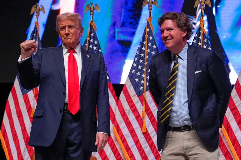 Republican presidential nominee former President Donald Trump speaks with Tucker Carlson.