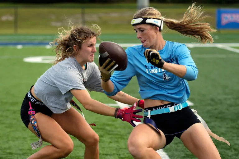 Ashlea Klam, right, tries to evade a defender during a training session for her flag football team at Keiser University.