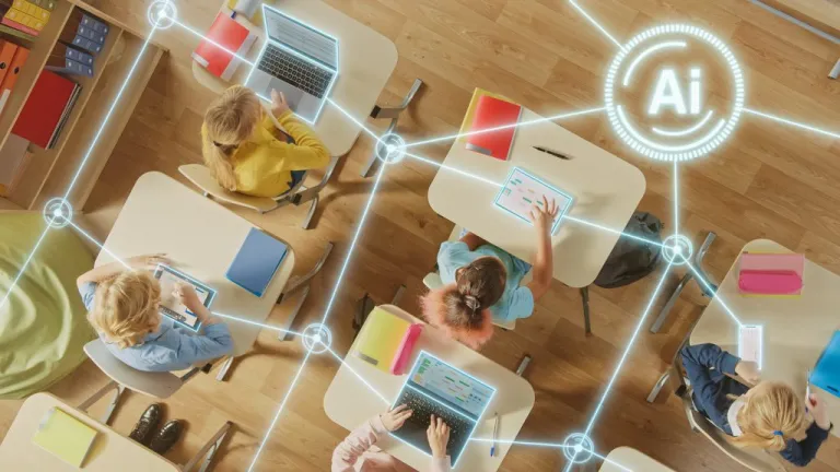 Children in a classroom use tablets and laptops.