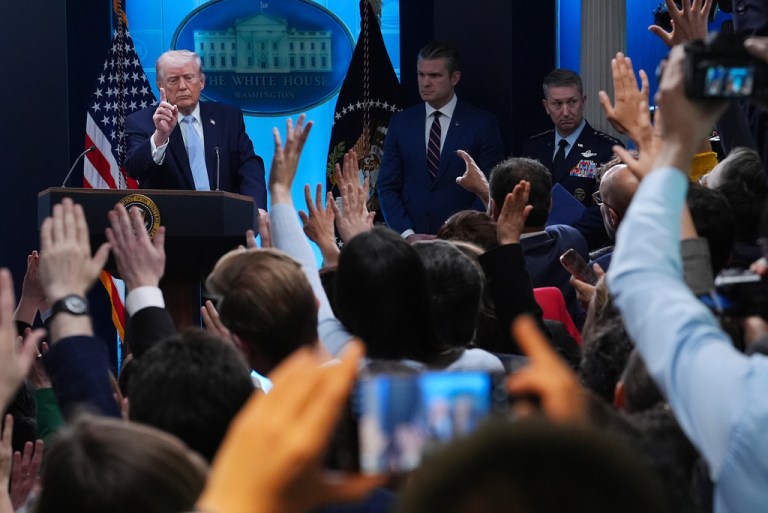 President Donald Trump gestures while speaking with reporters in the James Brady Press Briefing Room.