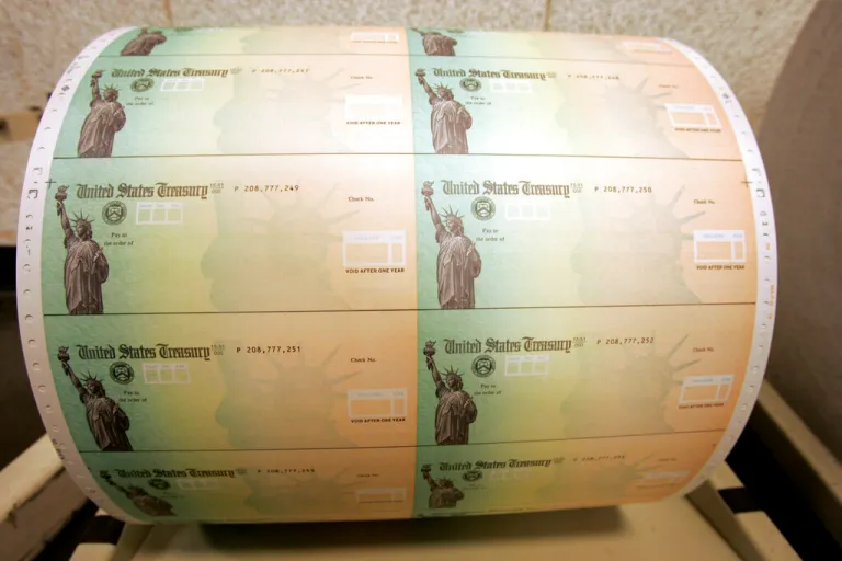 Blank U.S. Treasury checks on a roll.