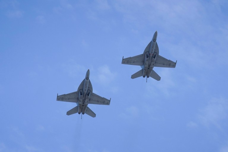 A pair of U.S. Navy F/A-18F Super Hornets fly