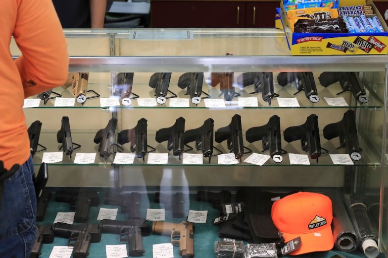 Handguns are displayed at a gun shop