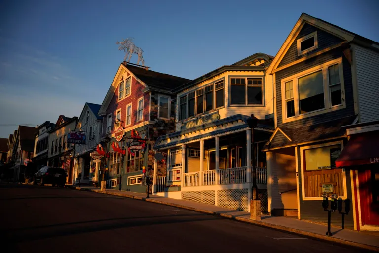 Early-morning light shines on shops.